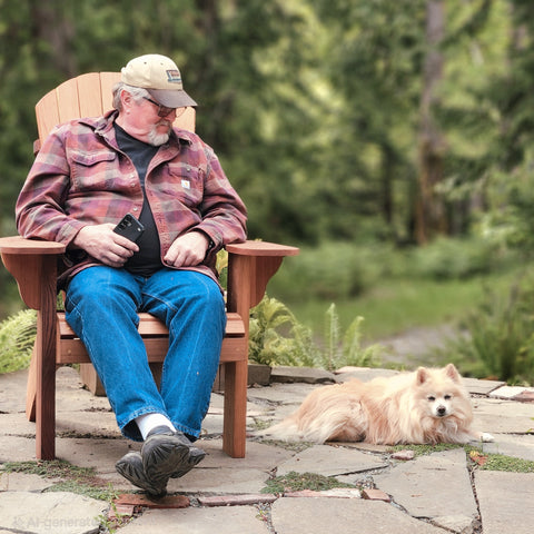 Man sitting in Handmade Cedar Adirondack Chair with Dog